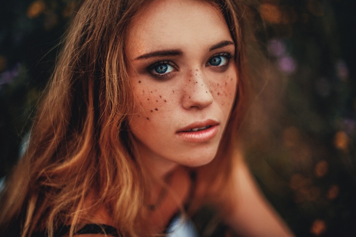 Woman with freckles and blue eyes