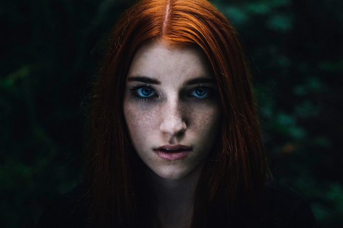 Portrait of a redhead woman with blue eyes and freckles