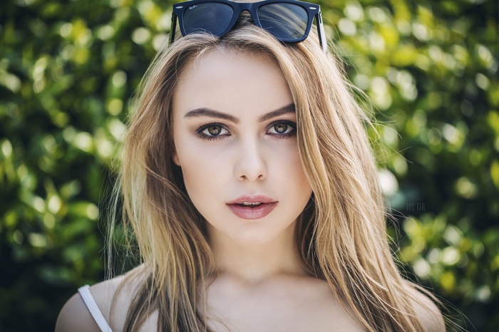 Woman with sunglasses on head, blonde hair