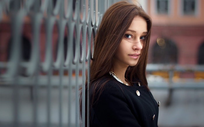 Portrait of a young woman in a black coat