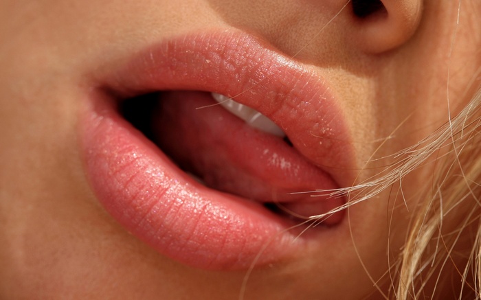 Close-up of a woman's mouth with tongue