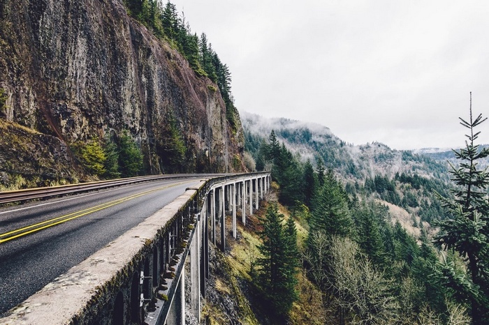 Road on a cliffside overlooking a forest