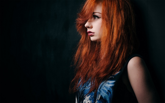 Redhead woman with red lipstick in profile