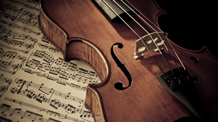 Violin resting on sheet music