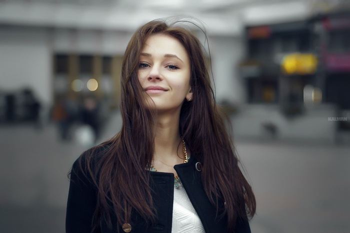 Brunette woman with long hair wearing a black coat