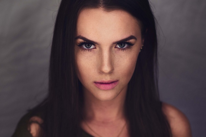 Woman with freckles looking directly at the camera