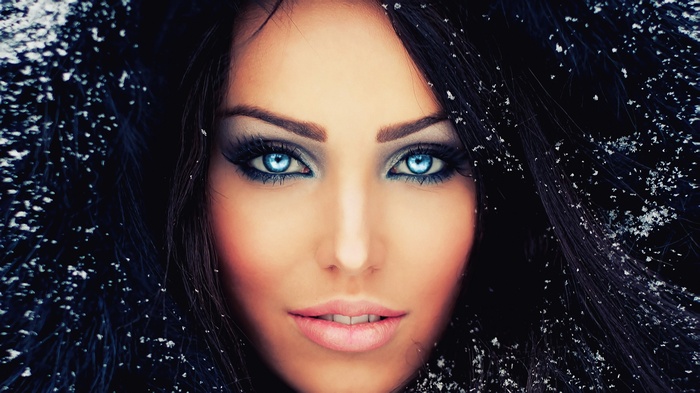 Woman with blue eyes and snow in her hair