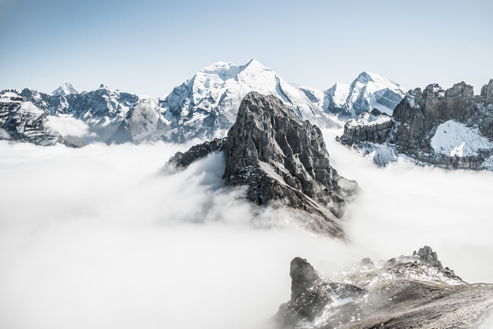 Snow-capped mountains above clouds in Switzerland
