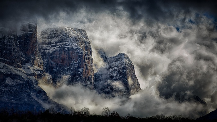 Snow-capped mountains in Greece shrouded in mist