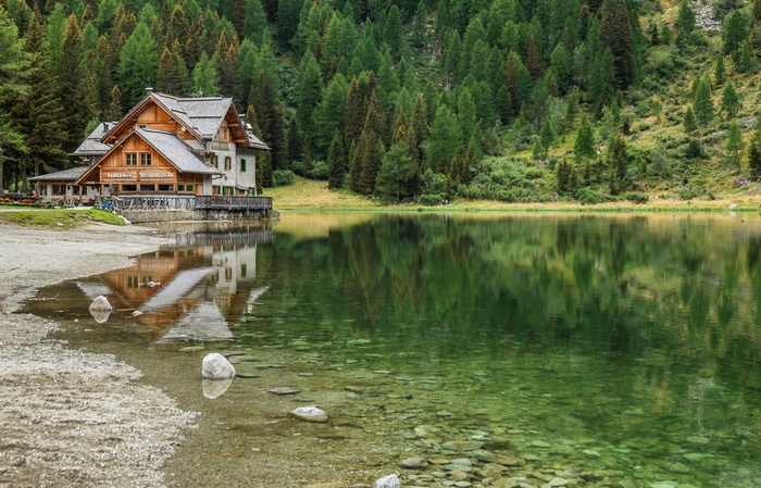Reflections of a Lakeside Cabin in Nambino, Italy