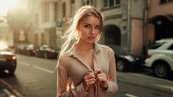 Woman in a patterned shirt on a city street