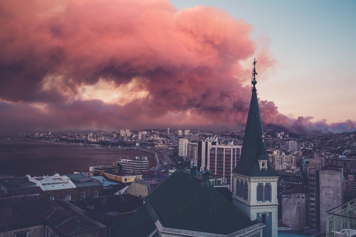 City skyline with smoke and church spire