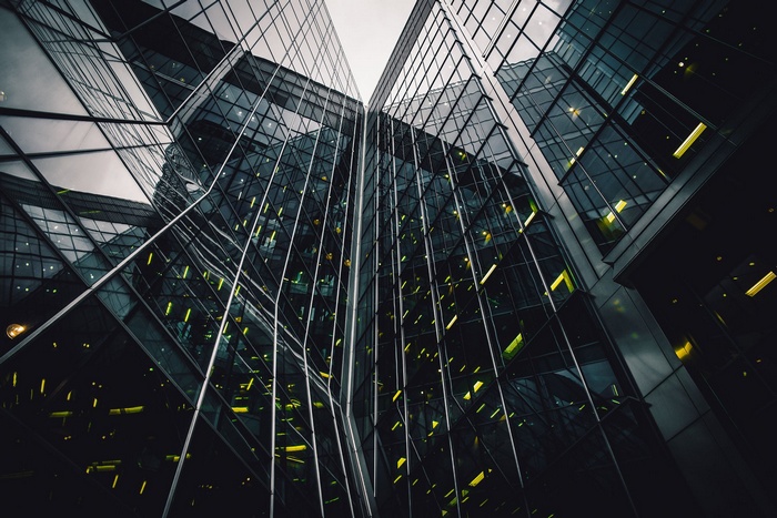 Modern glass buildings reflecting the sky