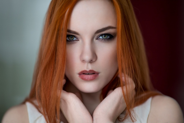 Zara Axeronias with red hair and white dress