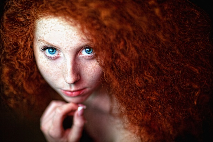 Redhead woman with blue eyes and freckles
