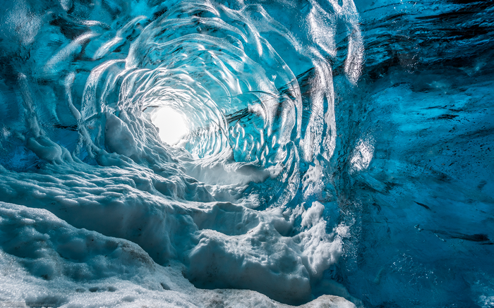 Inside a blue ice cave with snow