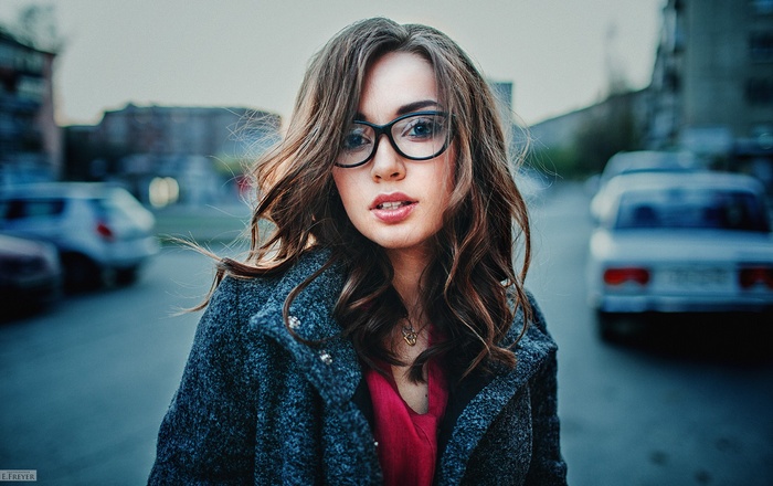 Portrait of Tonya with glasses and curly hair