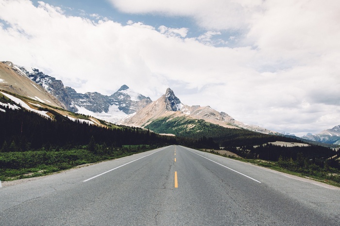 Road leading to snow-capped mountains