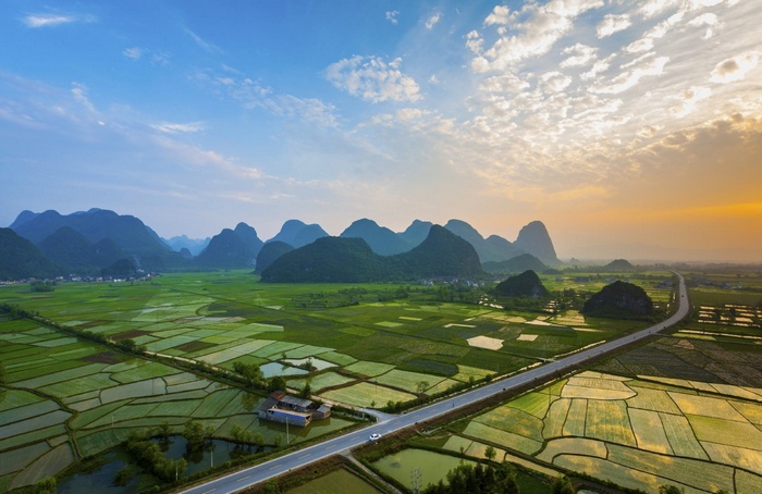 Rice paddies and karst mountains at sunset in China