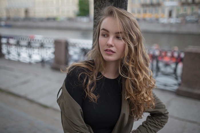 Julia Tavrina with curly blonde hair outdoors