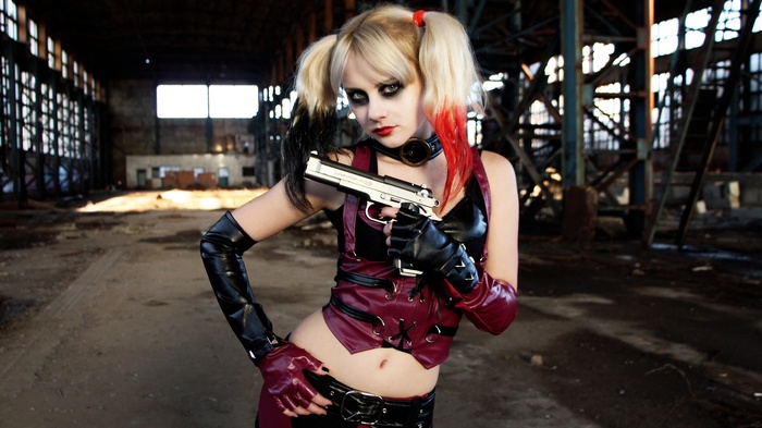 Harley Quinn cosplay with a pistol in an abandoned building