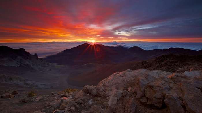 Sunset over mountains above clouds