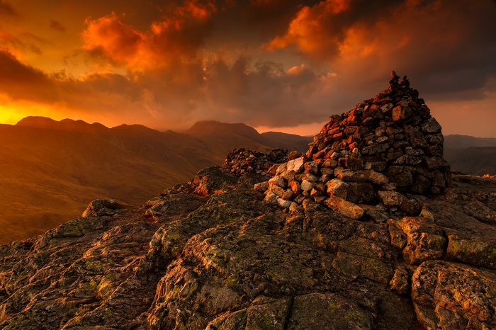 Cairn on a rocky mountain peak at sunset