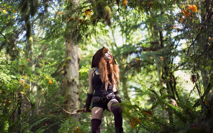 Katrina Wilkinson in a forest with a bow
