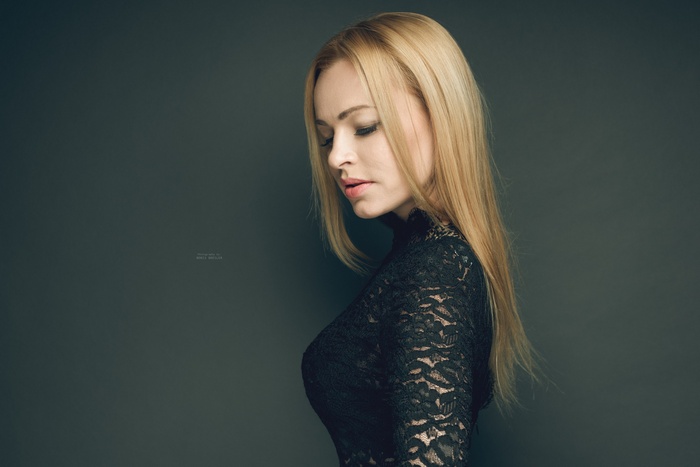 Portrait of a blonde woman in a black lace dress