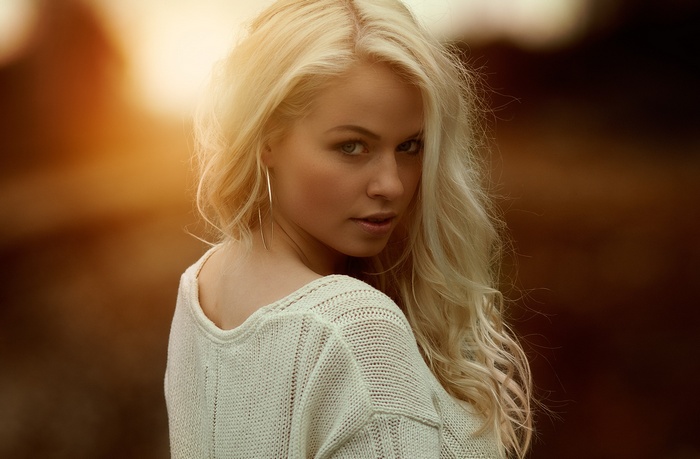 Portrait of Anniina Kangas with blonde hair at sunset