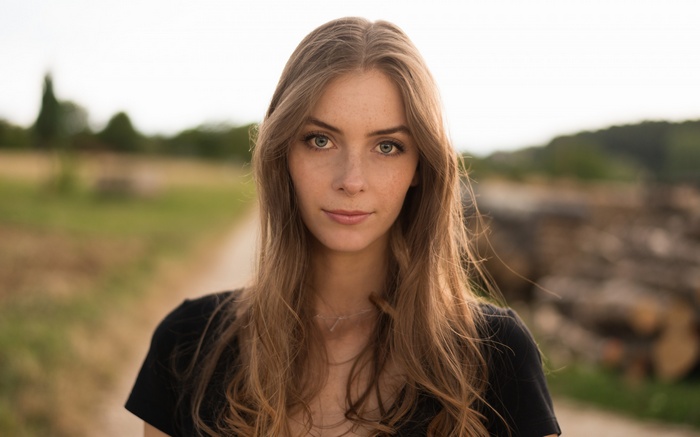 Woman with long wavy blonde hair looking at viewer