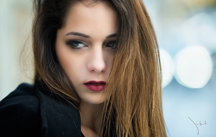 Portrait of a woman with auburn hair and makeup