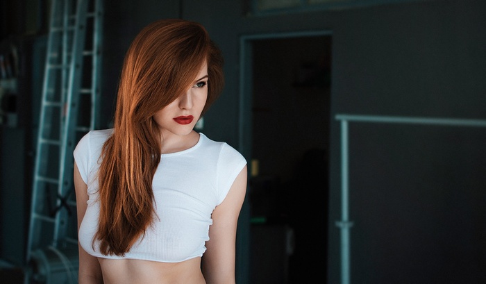 Redhead woman with red lipstick looking away