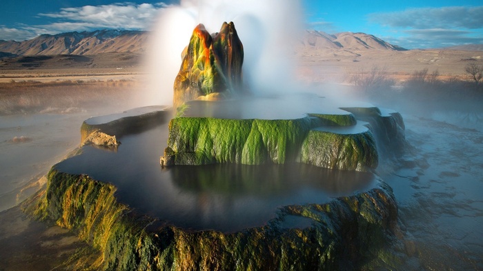 Fly Geyser in Nevada with Mountains and Steam
