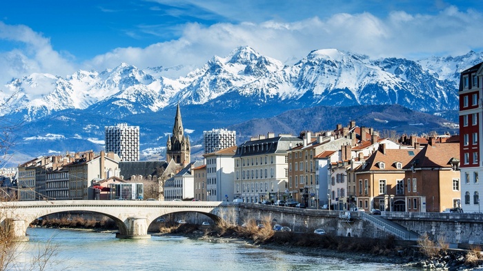 Grenoble cityscape with snowy Alps mountains and river