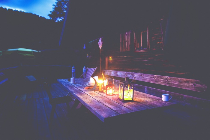 Lanterns on a wooden table at night