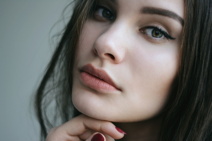 Close-up portrait of a young woman with dark hair