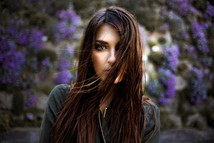 Portrait of a woman with hair blowing in front of her face
