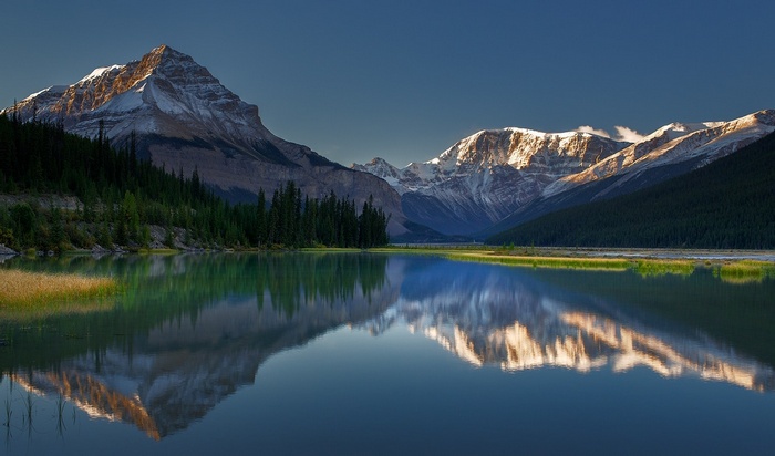 Rocky Mountains lake reflection at sunrise, Canada