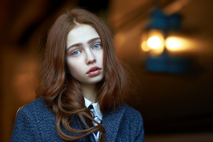 Portrait of a young redhead woman with blue eyes