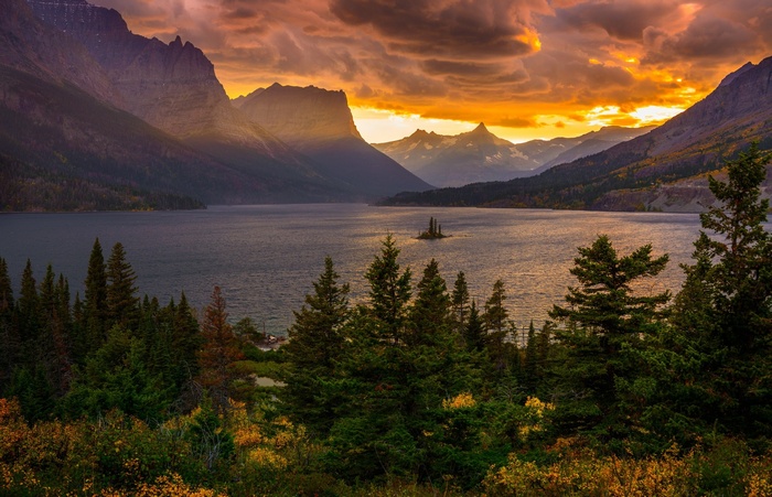 Sunset over mountains and lake with island