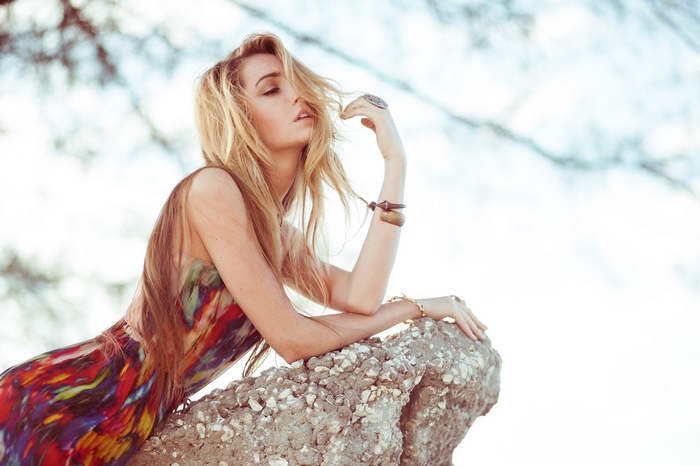 Woman with blonde hair in a colorful dress outdoors