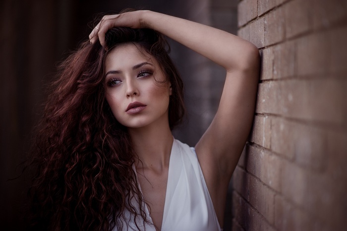 Savannah Cornejo leaning against a brick wall