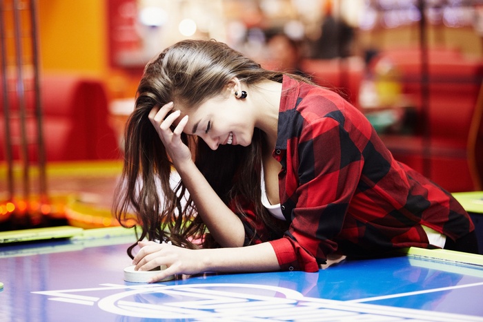 Woman playing air hockey