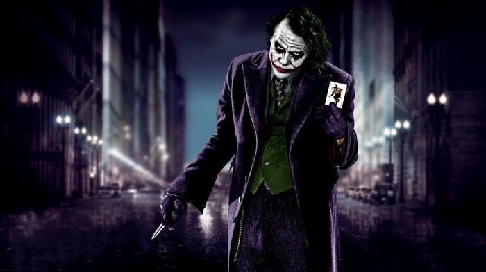The Joker holding a playing card in The Dark Knight