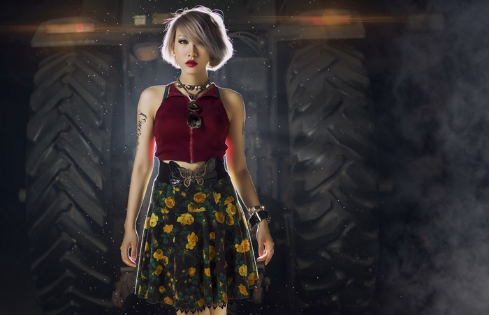 Asian woman in floral skirt and red top