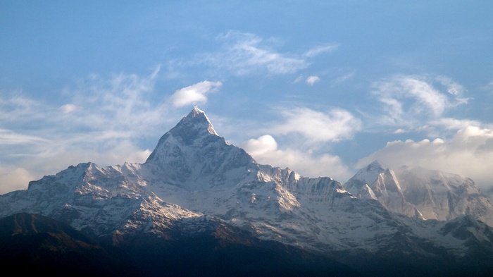 Snow-capped Machhapuchhre mountain in Nepal under a blue sky