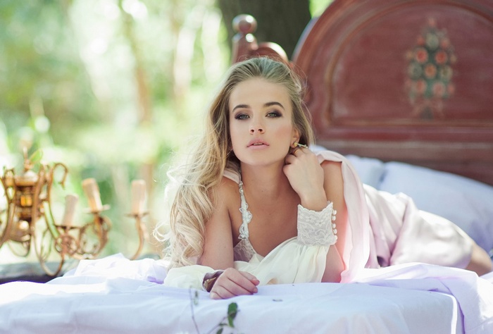 Liza Esther Mikrukova lying on a bed