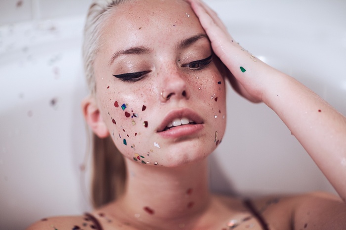 Woman with blonde hair and glitter on her face