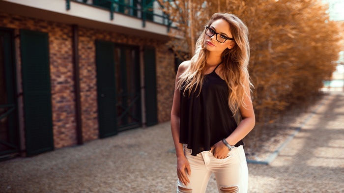 Woman with glasses and torn jeans by Peter Paszternak